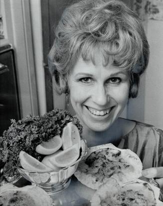 Jill showell holds a tray of Coquilles St