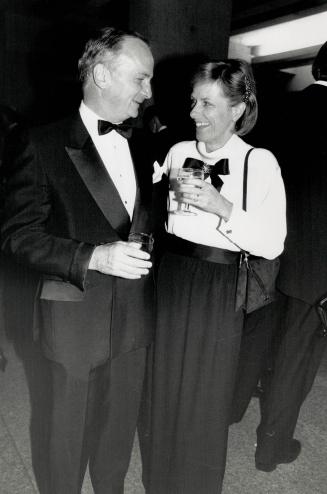 Above, Jim Connacher, one of the ball's sponsors, chats with his wife Mary, wearing a white silk blouse by Chanel and black skirt by Ungaro