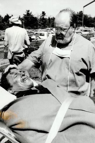Photo of William Conrad making one scene in movie Shock Trauma in which a injured state trooper, played by Beau Starr, is brought to the hospital by p(...)