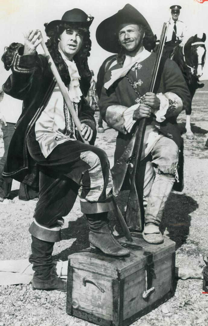 Costumed and bewigged as a 17th century explorer, Scarborough Mayor Paul Cosgrove (left) joins Reid Lewis, 34, at Bluffers Park yesterday as the moder(...)