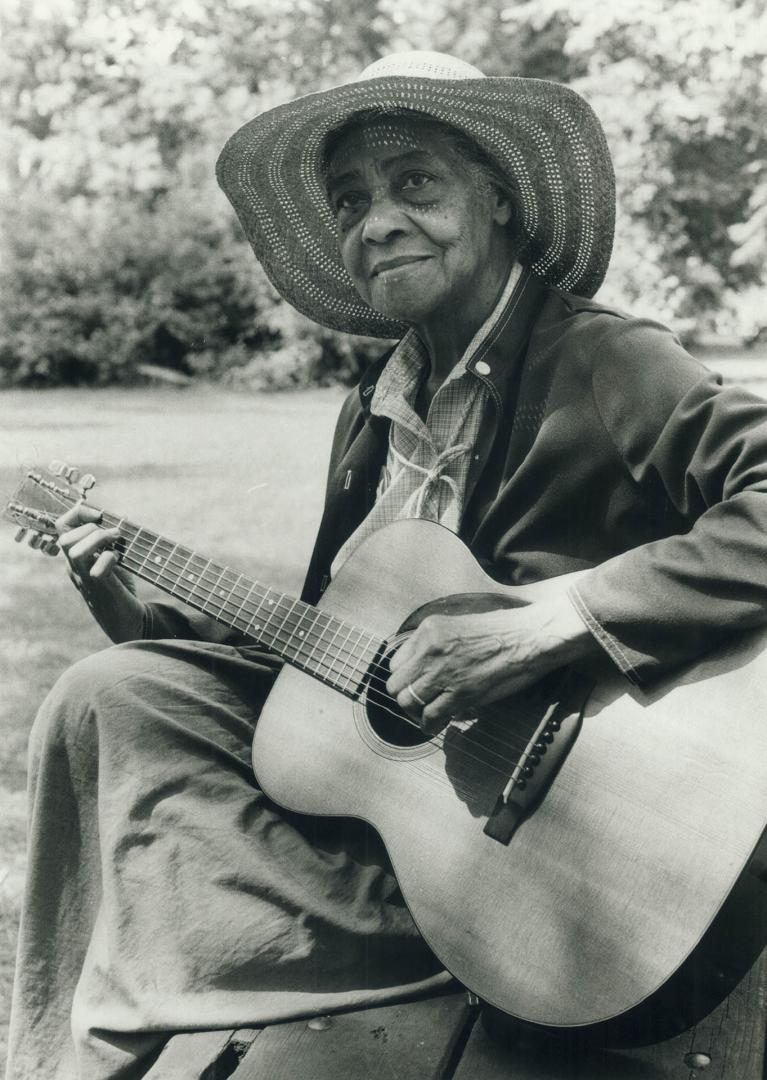 Strumming time. Elizabeth Cotton, 87-year-old composer of Freight Train and Cotton Fields, is one of the headliners performing this week end at the To(...)