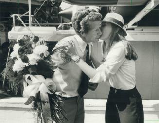 Burlington welcome: Calypso captain Marc Soviche got a kiss, flowers and a bottle of champagne to share with his crew from Helena Kazmierczak upon the ship's arrival in Burlington