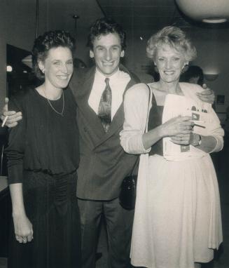 Image shows a gentleman in the centre with two ladies on both sides posing for a photo.
