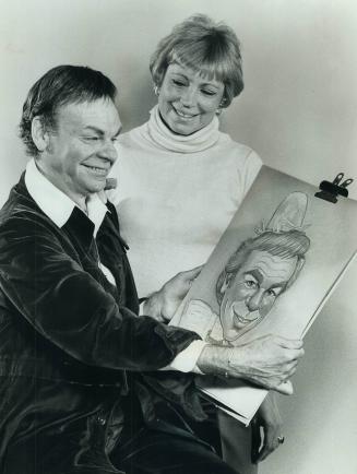 Actor Jack Creley meets a caricature of himself which is the work of Toronto artist Rae Goldman, who is seen with him