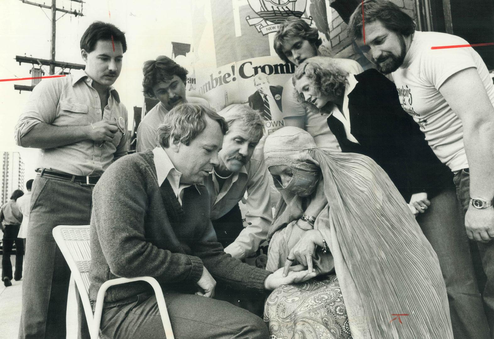 Crombie has palm read as Tony Brady watches
