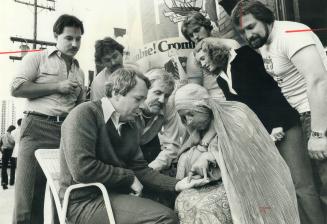 Crombie has palm read as Tony Brady watches