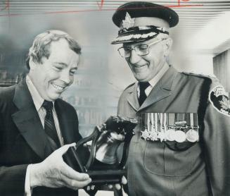 A bell for the mayor. Captain William Goodyear of Toronto Civic Employees War Veterans Honor Guard presents a copy of the Liberty Bell to city Mayor D(...)