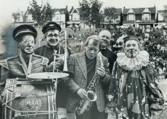 Mayor David Crombie picks up a sax and joins a clowns' band at Saturday's annual Thomas Foster picnic at Greenwood Park