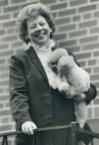 Relaxed: Scarborough Alderman Florence Cruickshank cuddles her toy poodle Beau during a moment of relaxation at her Alpaca Dr. home. A provincial cabinet minister calls her the consumate politician