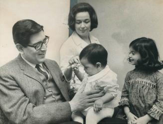 Clarinetist Henry Cuesta - with wife Janette, daughters Marion, 4, Lucinda, 7 months - may have started
