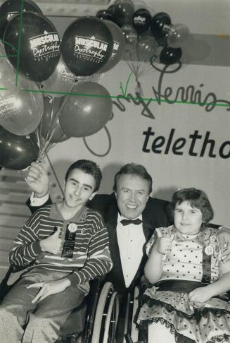 Team work: Mike darow, a host of weekend muscular dystrophy telethon, is cheered on by campaign assistants Leonard Falcao, 14, of Kingston and his sister Amanda, 9