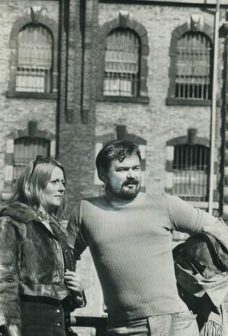 Ex-Guard at Toronto (Don) Jail, Gary Dassy, 32, and his girlfriend, Jane Mannerholm, 30, stand in front of the jail where Dassy says he helped beat up(...)