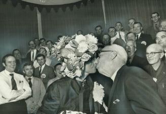 True Trades a Kiss for a Hat. East York Mayor True Davidson, wearing the flowered hat Scarborough Alderman Ted Littleford has just presented to her, g(...)