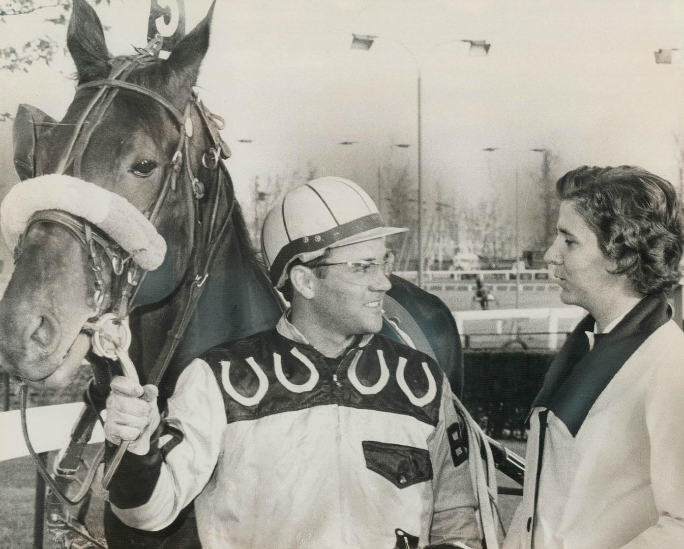 Della Young, winner of annual Joe Perlove Award, receives congratulations from horseman Brent Davies at Greenwood