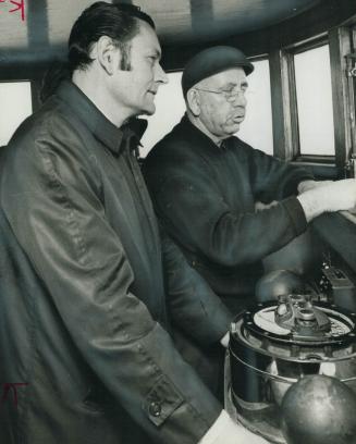 Fisheries minister Jack Davis (left) looks at the mercury-polluted water of Lake Erie from the wheelhouse of the John D