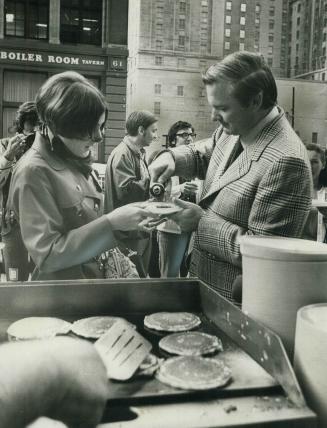 Pouring on the syrup, Premier William Davis flavors Elizabeth Cuviter's pancake at hour-long flap jack breakfast he threw today on the steps of Toront(...)