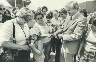 Davis, above, meets a reluctant voter-to-be during tour of Ontario Place