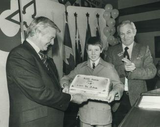Decade in power. Premier William Davis is given a birthday cake by 13-year-old Bradley Fadzean to commemorate the 10th anniversary of Davis's assumpti(...)