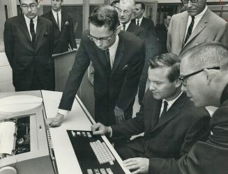 First school computer centre. Education Minister William Davis sits before new 1130 computer at Northview C.I. after opening first high school compute(...)