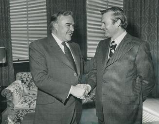 Switching the reins of power, former Ontario premier John Robarts (left) shakes hands with successor, PRemier William Davis, at Queen's Park yesterday(...)
