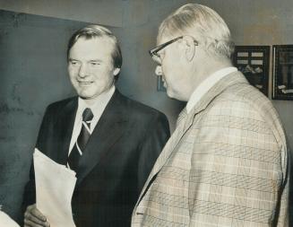 Premier William Davis and John MacBeth, chairman of the Legislature committee studying Ontario Hydro's warding of the contract to build its new head o(...)