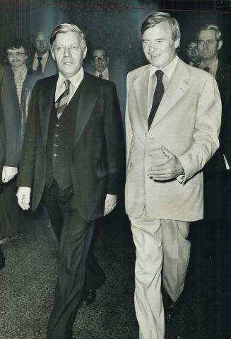 Premier William Davis leads West German Chancellor Helmut Schmidt (left) into a meeting yesterday at the Royal York Hotel of the premier's advisory co(...)