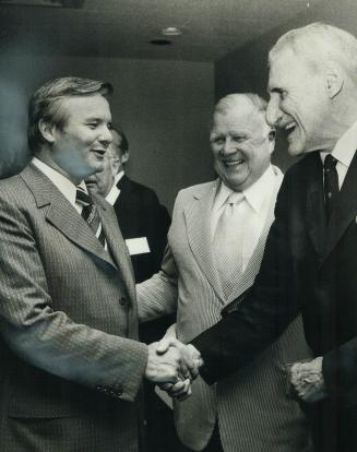 Ted Reeve (right) receives congratulations from Ontario Premier William Davis during testimonial dinner for the veteran sports columnist and former at(...)