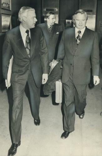 After talks about legislating 8,800 striking teachers back to work, Education Minister Thomas Wells and Premier William Davis leave a downtown hotel t(...)