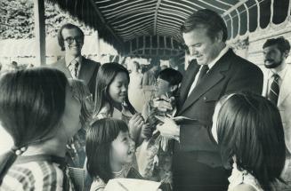 The Premier's Penmanship draws appreciative giggles from a group of little Chinese girls who surrounded Premier William Davis seeking autographs yeste(...)