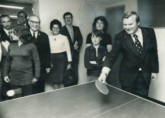 Premier William Davis returns the ball to his teenaged opponent in a ping-pong game in Regent Park yesterday