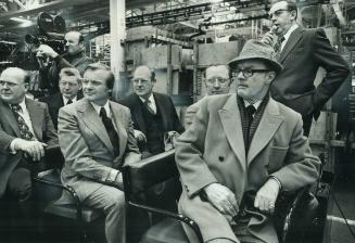 At the General Motors Plant in Oshawa, Premier William Davis (third from left) examines the operation from the tour train. It was billed as a meet-the(...)
