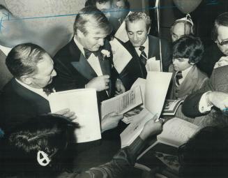 Man of the hour for his support of Israel, Premier William Davis signs autographs last night at Toronto Negev Dinner sponsored by Jewish National Fund(...)