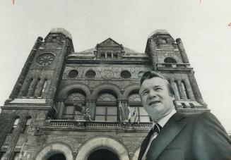 Ontario Premier William Davis stands in front of the legislature where he normally does business at Queen's Park