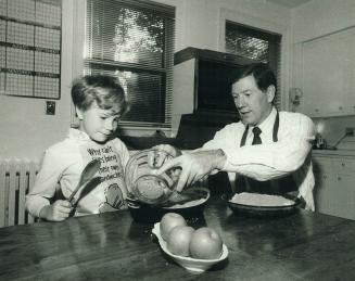 TV chef: Global television anchorman John Dawe and son Jonathan prepare apple crisp for Father's Day