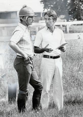 Canadian equestrian Jim Day, left, talks to Michael Pate, coach of the Three Day event team