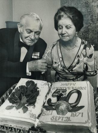 TTC Chairman Ralph Day and his wife Vera cut a cake prepared for their 50th wedding anniversary yesterday