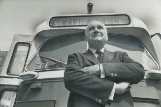 Ralph Day, chairman of the Toronto Transit Commission, looks to the future from in front of one of his streetcars
