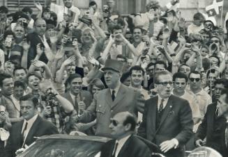 Jubilant Montrealers swarm around French President Charles de Gaulle during his visit to the city yesterday