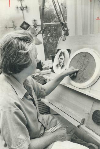 Medal designer Dora de Pedery Hunt works on medal she's making to mark 100th anniversary of the granting of Commonwealth's first bachelor's degree to (...)