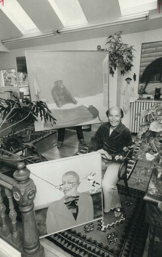 Louis De Niverville in his living room/studio with two of his paintings