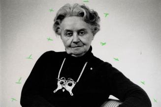Portrait of the artist: Hungarian-born artist Dora De Pedery-Hunt, wears her small sterling silver sculpture entitled The Kiss as a dramatic necklace over a turtleneck