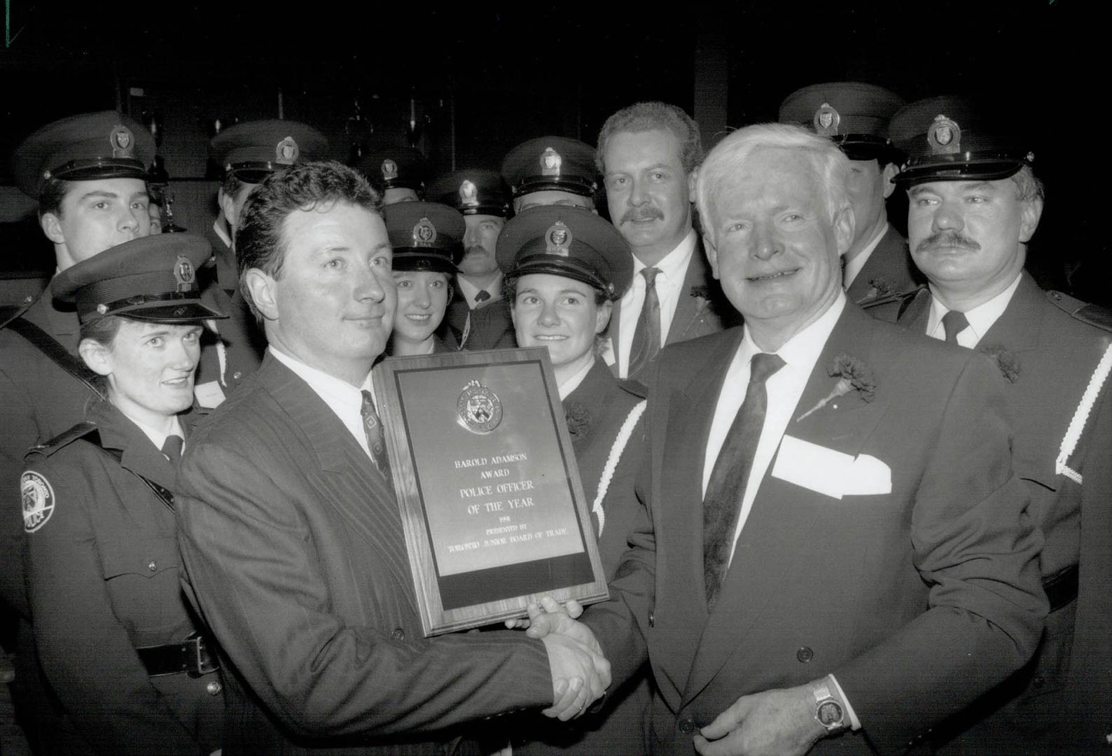 Survivor. Detective Larry Dee is congratulated by Chief William McCormack after getting the Police Officer of the year award last night. Other finalis(...)