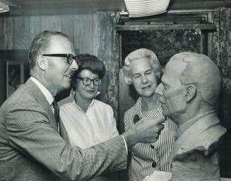 Mayor Dennison, wife (R.) view work of Mrs. Ethel Sostay. Even her grandchildren would recognize who it was, Mrs. Dennison exclaimed