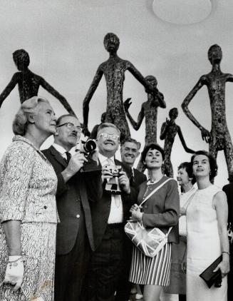 Camera at the ready, Mayor William Dennison prepares to take a shot of Henry Moore statue behind him at Expo yesterday
