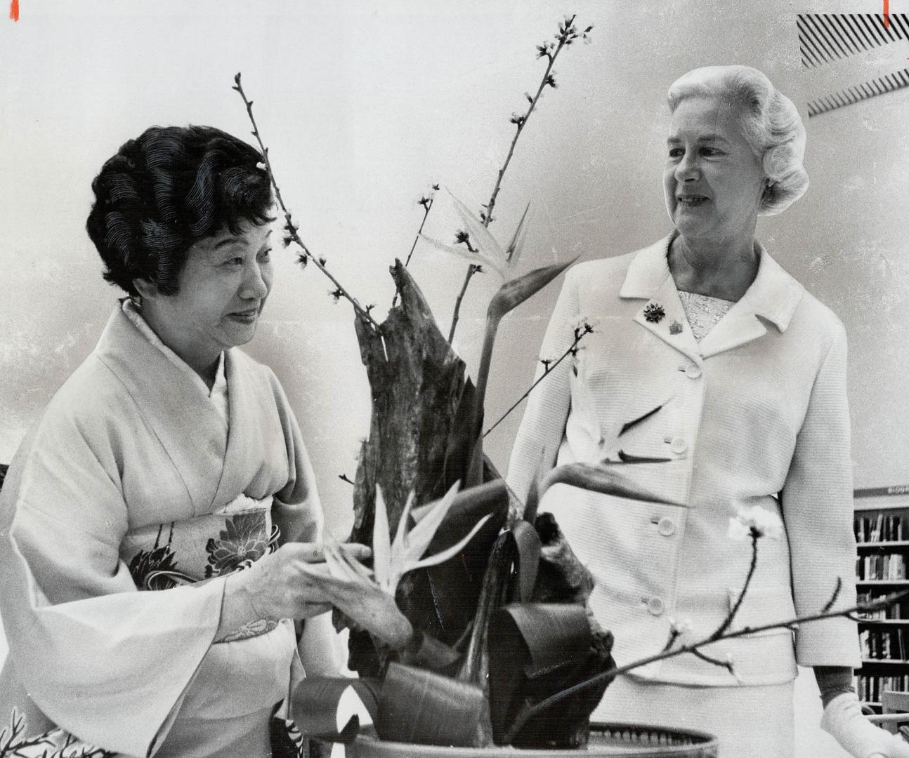 Mrs. William Dennison admires some of the Japanese flower arrangements with Mrs Fuji Maasaki. Mrs. Dennison opened the exhibition of Japanese flower a(...)