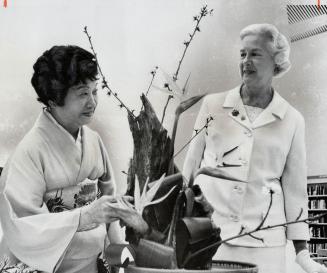 Mrs. William Dennison admires some of the Japanese flower arrangements with Mrs Fuji Maasaki. Mrs. Dennison opened the exhibition of Japanese flower a(...)
