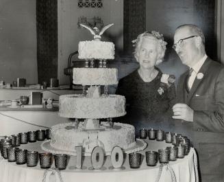 U.S. club marks 50 years. Mayor William Dennison admires the artistry of the huge birthday ake that was the focal point at the American Women's club g(...)