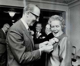 Flowers for a foe. They may be arch political foes, but mayoralty hopeful Margaret Campbell is all smiles as Mayor William Dennison pins on a corsage (...)