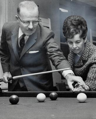The Mayor takes a cue. Mayor William Dennison gives Controller June Marks a few pointers on how to line up a billiard shot Saturday when they attended(...)