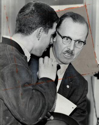 Huddle on the Hustings. Alex Ginou gives Controller William Dennison an earful during an election meeting last night at Hillcrest public school. The H(...)